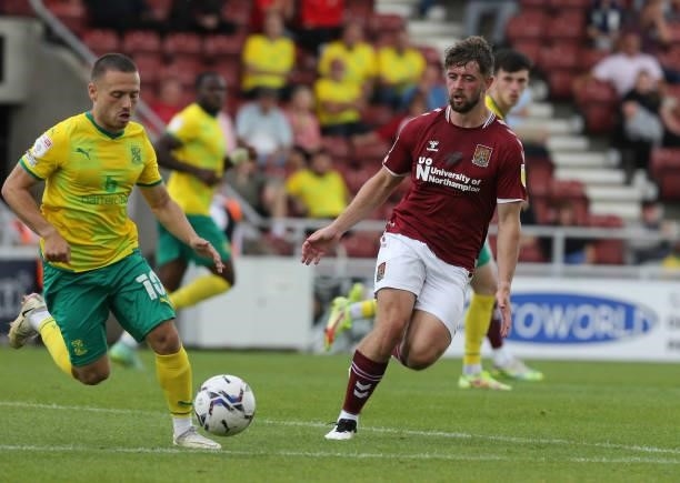 Jack Sowerby of Northampton Town plays the ball past Jack Payne of Swindon Town during the Sky Bet League Two match between Northampton Town and...