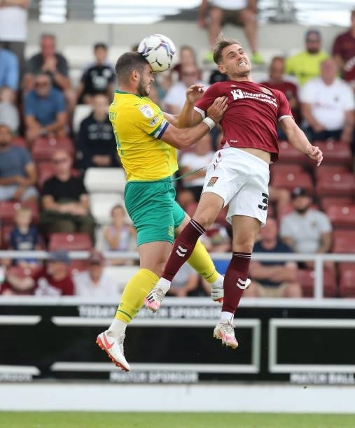 Dion Conroy of Swindon Town heads the ball under pressure from Danny Rose of Northampton Town during the Sky Bet League Two match between Northampton...