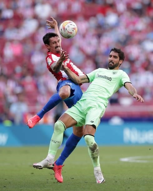 Stefan Savic of Athletic Club wins the header behind Raul Garcia of Athletic Club during the La Liga Santander match between Club Atletico de Madrid...