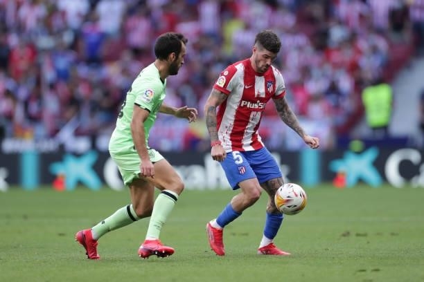 Rodrigo de Paul of Atletico de Madrid competes for the ball with Inigo Lekue of Athletic Club during the La Liga Santander match between Club...