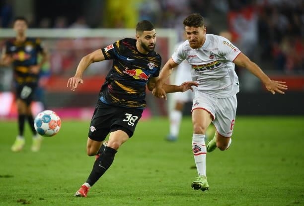 Josko Gvardiol of Leipzig and Salih Oezcan of 1. FC Koeln compete for the ball during the Bundesliga match between 1. FC Köln and RB Leipzig at...