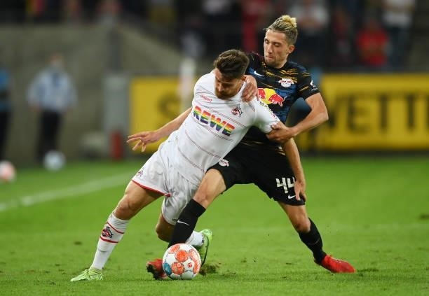Salih Oezcan of 1. FC Koeln is challenged by Kevin Kampl of Leipzig during the Bundesliga match between 1. FC Köln and RB Leipzig at...