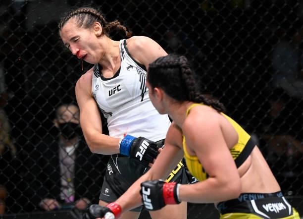 Ariane Lipski of Brazil punches Mandy Bohm of Germany in a flyweight fight during the UFC Fight Night event at UFC APEX on September 18, 2021 in Las...
