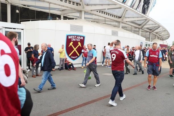 Fans arrive at the stadium prior to the Premier League match between West Ham United and Manchester United at London Stadium on September 19, 2021 in...