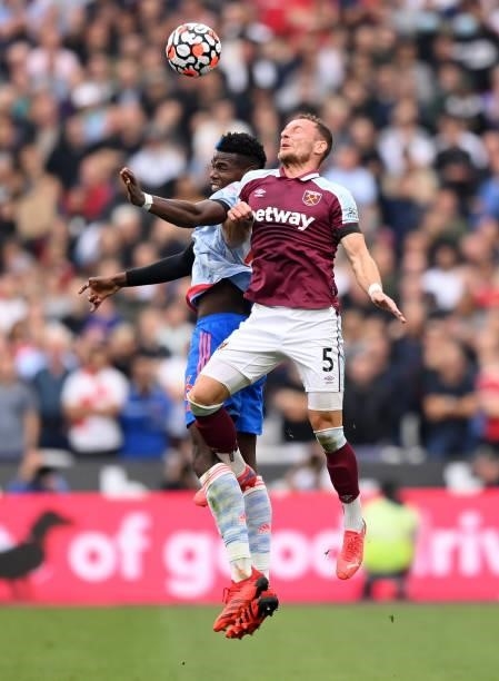 Paul Pogba of Manchester United competes for a header with Vladimir Coufal of West Ham United during the Premier League match between West Ham United...