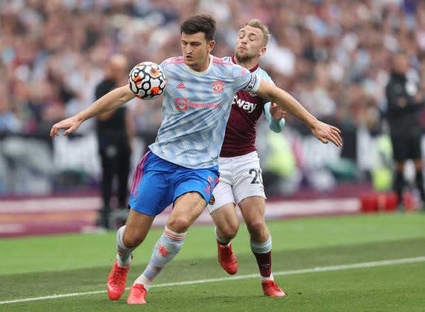 Harry Maguire of Manchester United battles for possession with Jarrod Bowen of West Ham United during the Premier League match between West Ham...