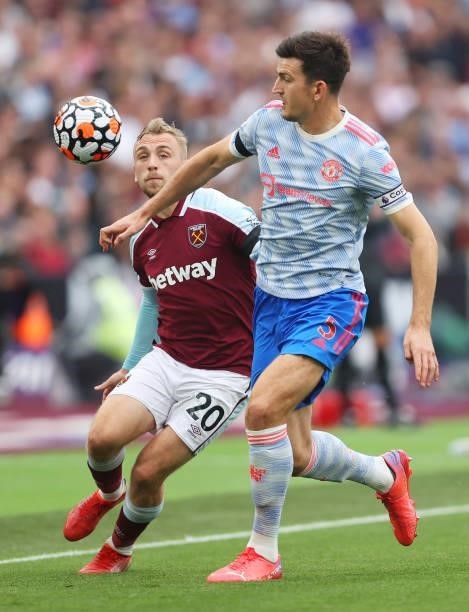 Harry Maguire of Manchester United battles for possession with Jarrod Bowen of West Ham United during the Premier League match between West Ham...