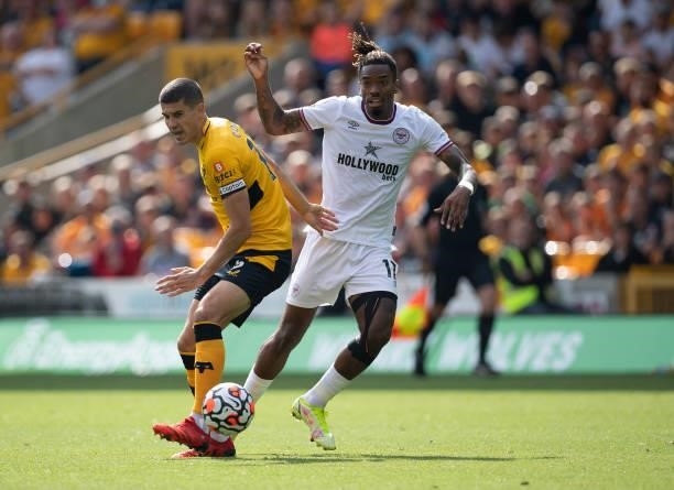 Ivan Toney of Brentford and Conor Coady of Wolverhampton Wanderers during the Premier League match between Wolverhampton Wanderers and Brentford at...
