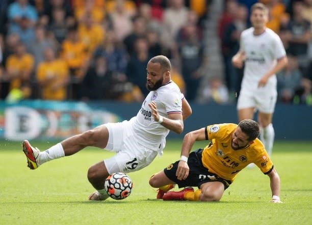 Bryan Mbeumo of Brentford and João Moutinho of Wolverhampton Wanderers during the Premier League match between Wolverhampton Wanderers and Brentford...