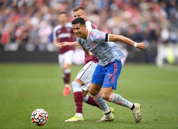 Cristiano Ronaldo of Manchester United is challenged by Andriy Yarmolenko of West Ham United during the Premier League match between West Ham United...