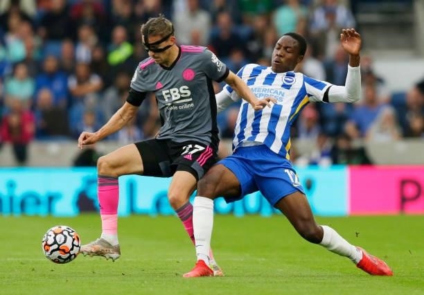 Enock Mwepu of Brighton & Hove Albion battles for possession with Timothy Castagne of Leicester City during the Premier League match between Brighton...