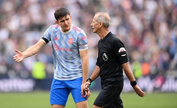 Harry Maguire of Manchester United argues with Referee, Martin Atkinson after he awards a penalty during the Premier League match between West Ham...