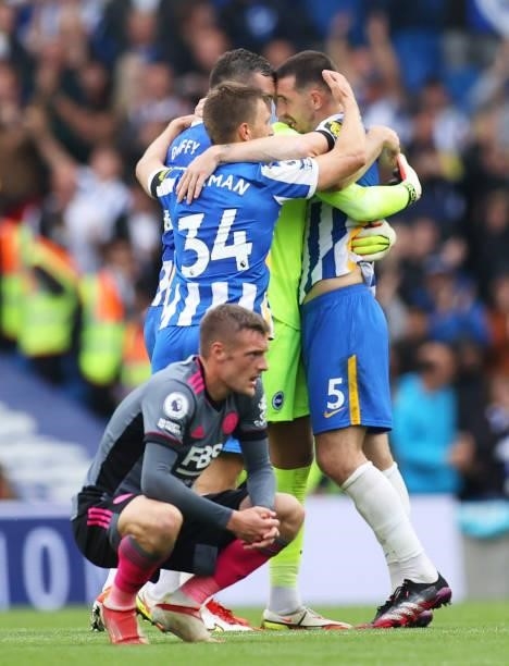 Players of Brighton & Hove Albion celebrate their victory as Jamie Vardy of Leicester City reacts following the Premier League match between Brighton...