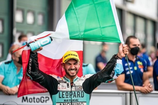 Moto3 rider Dennis Foggia of Italy and Leopard Racing celebrates his win at parc ferme with his Italian flag during the race of the MotoGP Gran...