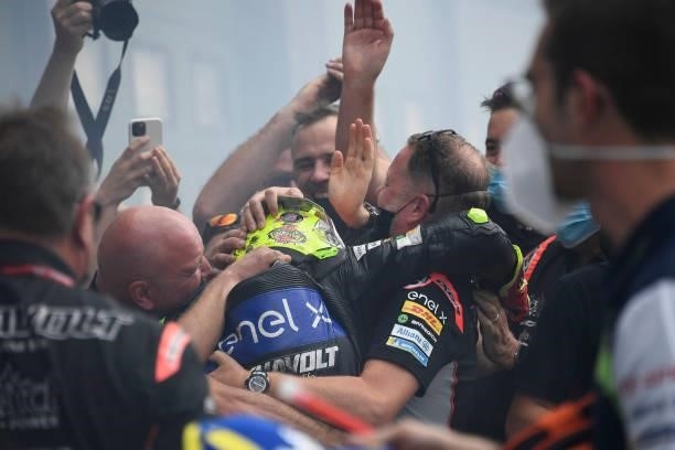 Dominique Aegerter of Germany and Dynavolt Intact GP celebrates with his team under the podium during the MotoE race 2 during the MotoGP Of San...