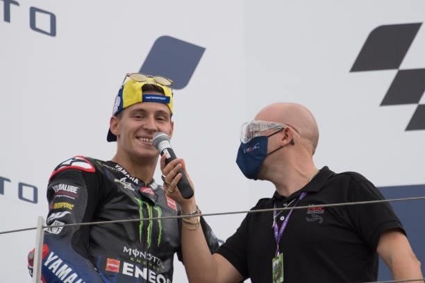 Fabio Quartararo of France and Monster Energy Yamaha MotoGP Team celebrates and speaks with fans on the podium during the MotoGP race during the...