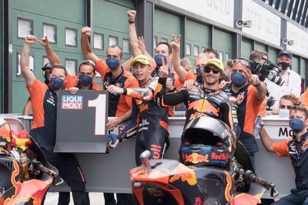 Raul Fernandez of Spain and Red Bull KTM Ajo and Remy Gardner of Australia and Red Bull KTM Ajo celebrate with team under the podium during the Moto2...