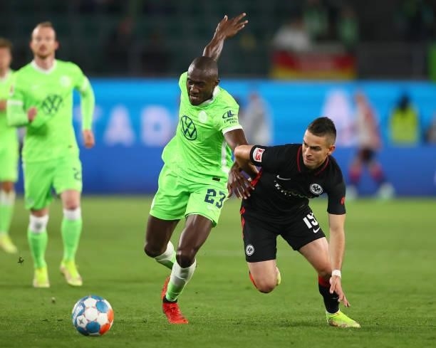 Joshua Guilavogui of Wolfsburg fights for the ball with Rafael Santos Borre of Frankfurt during the Bundesliga match between VfL Wolfsburg and...