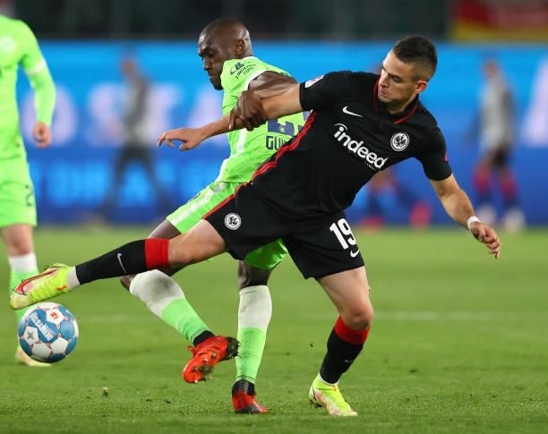 Joshua Guilavogui of Wolfsburg fights for the ball with Rafael Santos Borre of Frankfurt during the Bundesliga match between VfL Wolfsburg and...