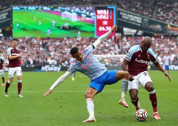 Mason Greenwood of Manchester United and Angelo Ogbonna of West Ham United battle for the ball during the Premier League match between West Ham...