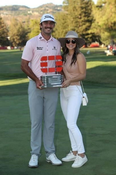 Max Homa and his wife Lacey celebrate with the champion's trophy after winning the Fortinet Championship at Silverado Resort and Spa on September 19,...