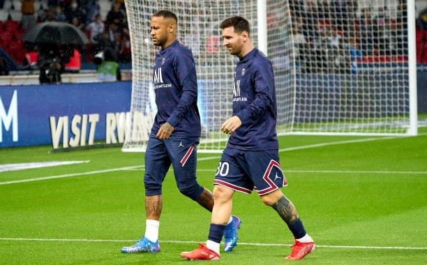 Neymar Jr of Paris Saint Germain and Lionel Messi of Paris Saint Germain walk out prior to the Ligue 1 Uber Eats match between Paris Saint Germain...
