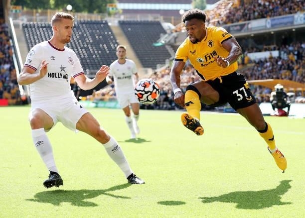 Adama Traore of Wolverhampton Wanderers controls the ball under pressure from Kristoffer Ajer of Brentford during the Premier League match between...