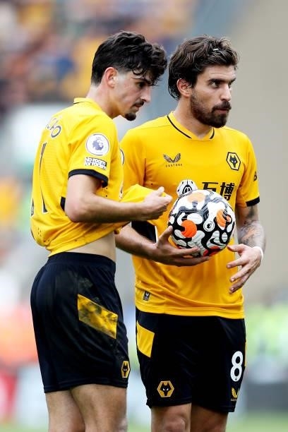 Francisco Trincao and Ruben Neves of Wolverhampton Wanderers prepare to take a free kick during the Premier League match between Wolverhampton...
