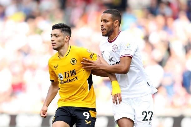 Raul Jimenez of Wolverhampton Wanderers calls for the ball under pressure from Zanka of Brentford during the Premier League match between...