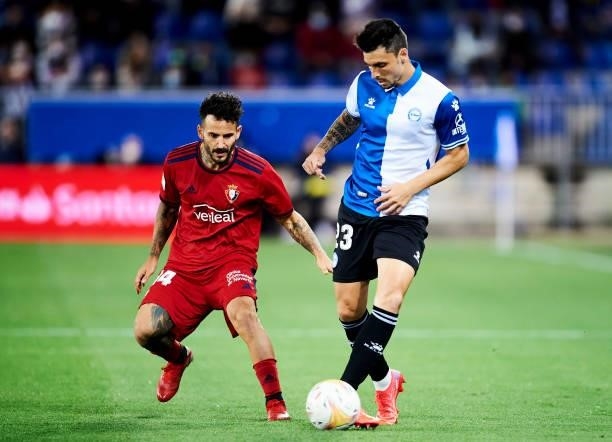 Ximo Navarro of Deportivo Alaves duels for the ball with Ruben Garcia of CA Osasuna during the La Liga Santander match between Deportivo Alaves and...