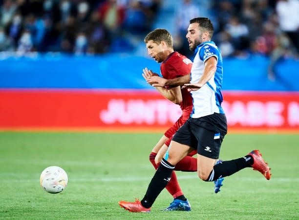 Luis Rioja of Deportivo Alaves duels for the ball with Darko Brasanac of CA Osasuna during the La Liga Santander match between Deportivo Alaves and...