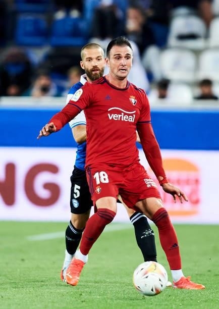 Victor Laguardia of Deportivo Alaves duels for the ball with Kike Garcia of CA Osasuna during the La Liga Santander match between Deportivo Alaves...