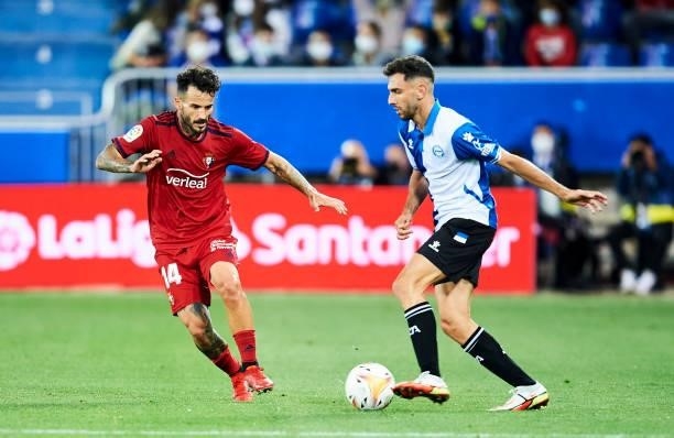 Ivan Martin of Deportivo Alaves duels for the ball with Ruben Garcia of CA Osasuna during the La Liga Santander match between Deportivo Alaves and CA...