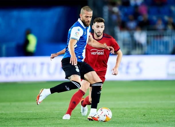 Victor Laguardia of Deportivo Alaves duels for the ball with Jon Moncayola of CA Osasuna during the La Liga Santander match between Deportivo Alaves...
