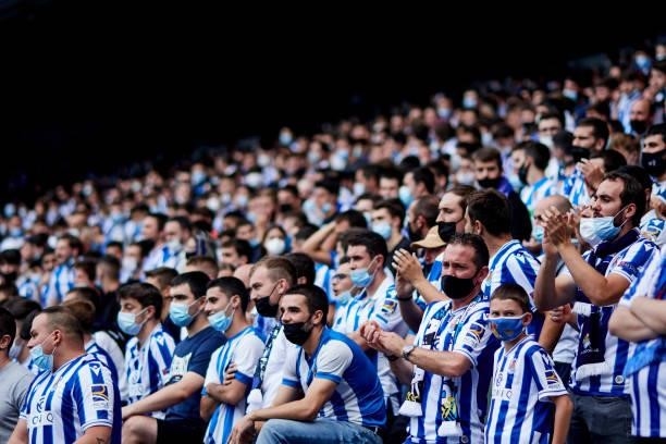 Fans of Real Sociedad support their team during the La Liga Santander match between Real Sociedad and Sevilla FC at Reale Arena on September 19, 2021...