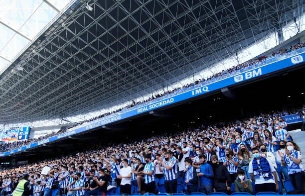 Fans of Real Sociedad support their team during the La Liga Santander match between Real Sociedad and Sevilla FC at Reale Arena on September 19, 2021...