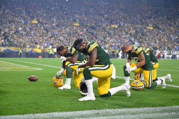 Adrian Amos of the Green Bay Packers takes a knee before the game against the Detroit Lions at Lambeau Field on September 20, 2021 in Green Bay,...