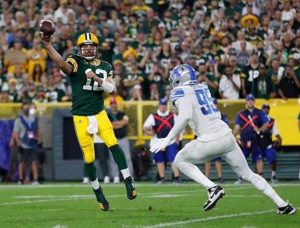 Aaron Rodgers of the Green Bay Packers throws under pressure from Julian Okwara of the Detroit Lions during the first half at Lambeau Field on...