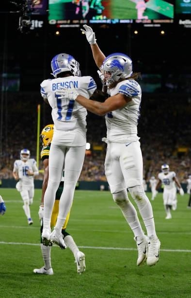 Hockenson of the Detroit Lions celebrates a touchdown reception with teammate Trinity Benson during the first half against the Green Bay Packers at...