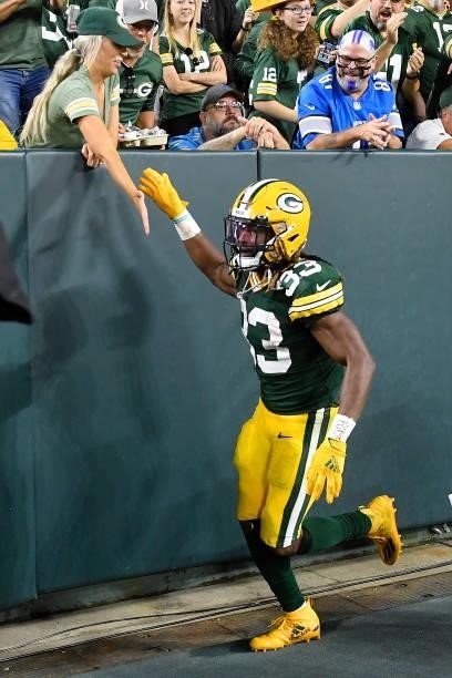 Aaron Jones of the Green Bay Packers celebrates a touchdown with fans against the Detroit Lions during the first half at Lambeau Field on September...