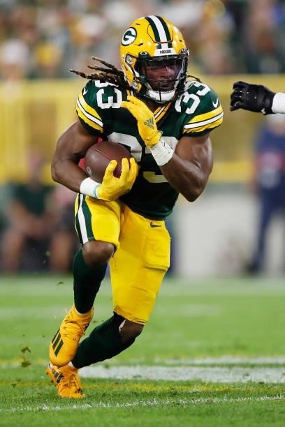 Aaron Jones of the Green Bay Packers runs against the Detroit Lions during the first half at Lambeau Field on September 20, 2021 in Green Bay,...