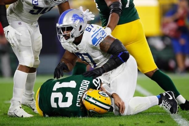 Nick Williams of the Detroit Lions sacks Aaron Rodgers of the Green Bay Packers during the first half at Lambeau Field on September 20, 2021 in Green...