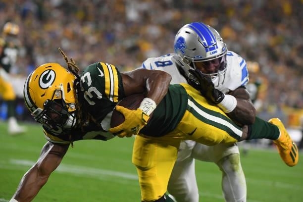 Aaron Jones of the Green Bay Packers dives against Jamie Collins of the Detroit Lions against the Detroit Lions during the first half at Lambeau...