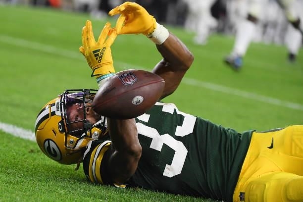 Aaron Jones of the Green Bay Packers drops the ball against the Detroit Lions during the first half at Lambeau Field on September 20, 2021 in Green...