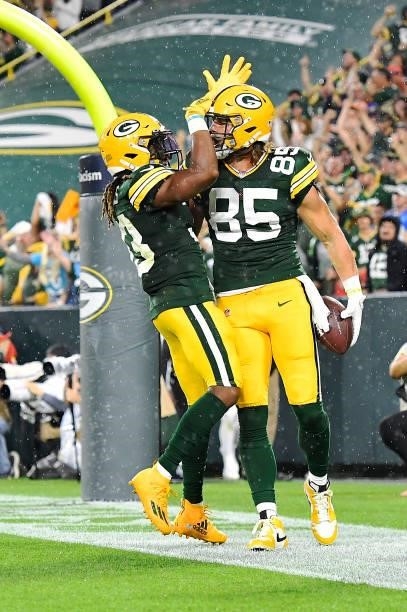 Robert Tonyan of the Green Bay Packers and Aaron Jones celebrate a touchdown against the Detroit Lions during the second half at Lambeau Field on...