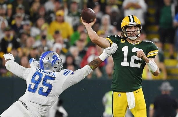 Aaron Rodgers of the Green Bay Packers is pressured by Romeo Okwara of the Detroit Lions during the second half at Lambeau Field on September 20,...