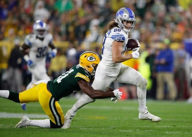 Hockenson of the Detroit Lions runs against Adrian Amos of the Green Bay Packers during the second half at Lambeau Field on September 20, 2021 in...
