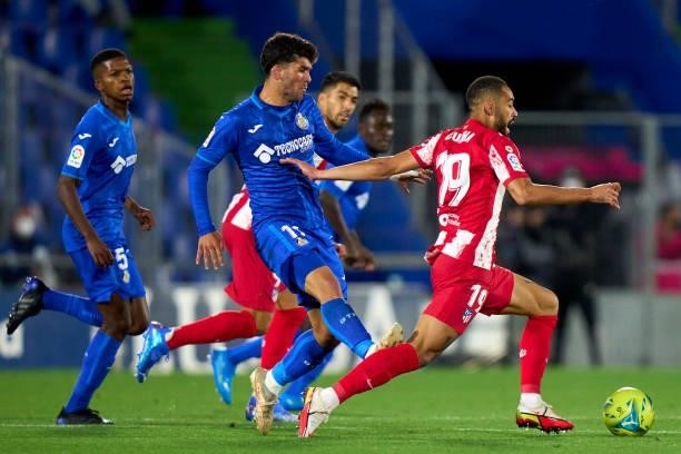 Carles Alena of Getafe tackles for the red card to Matheus Cunha of Atletico de Madrid during the La Liga Santander match between Getafe CF and Club...