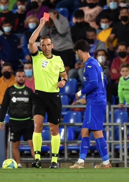 Carles Alena of Getafe is shown a red card by Match Referee Guillermo Cuadra Fernández during the La Liga Santander match between Getafe CF and Club...