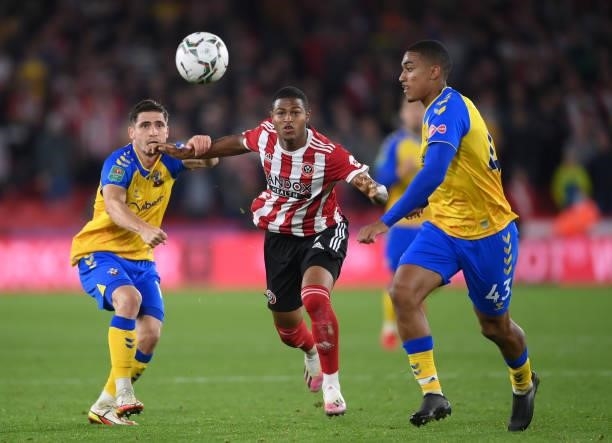 Rhian Brewster of Sheffield United is put under pressure by Romain Perraud of Southampton and Yan Valery of Southampton during the Carabao Cup Third...